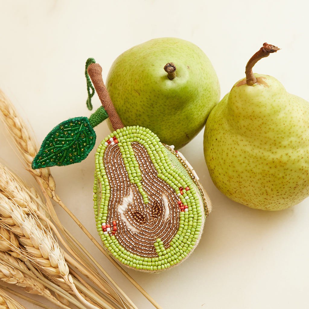 Cotton-linen pear ornament featuring detailed beadwork and curved fruit design, ideal for festive tables or kitchen trees.