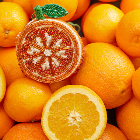 Citrus-themed orange ornament featuring radiant beadwork and elegant linen texture, ideal for gifting or display.