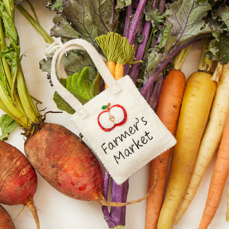 Hand-felted farmer’s market tote ornament filled with wool carrots and leafy greens – handmade spring decor from the Gardening Collection.