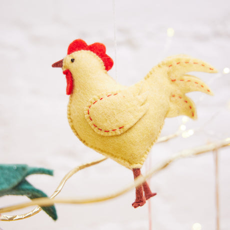 Strutting yellow rooster ornament made of natural wool, ideal for farmhouse or holiday tree décor.