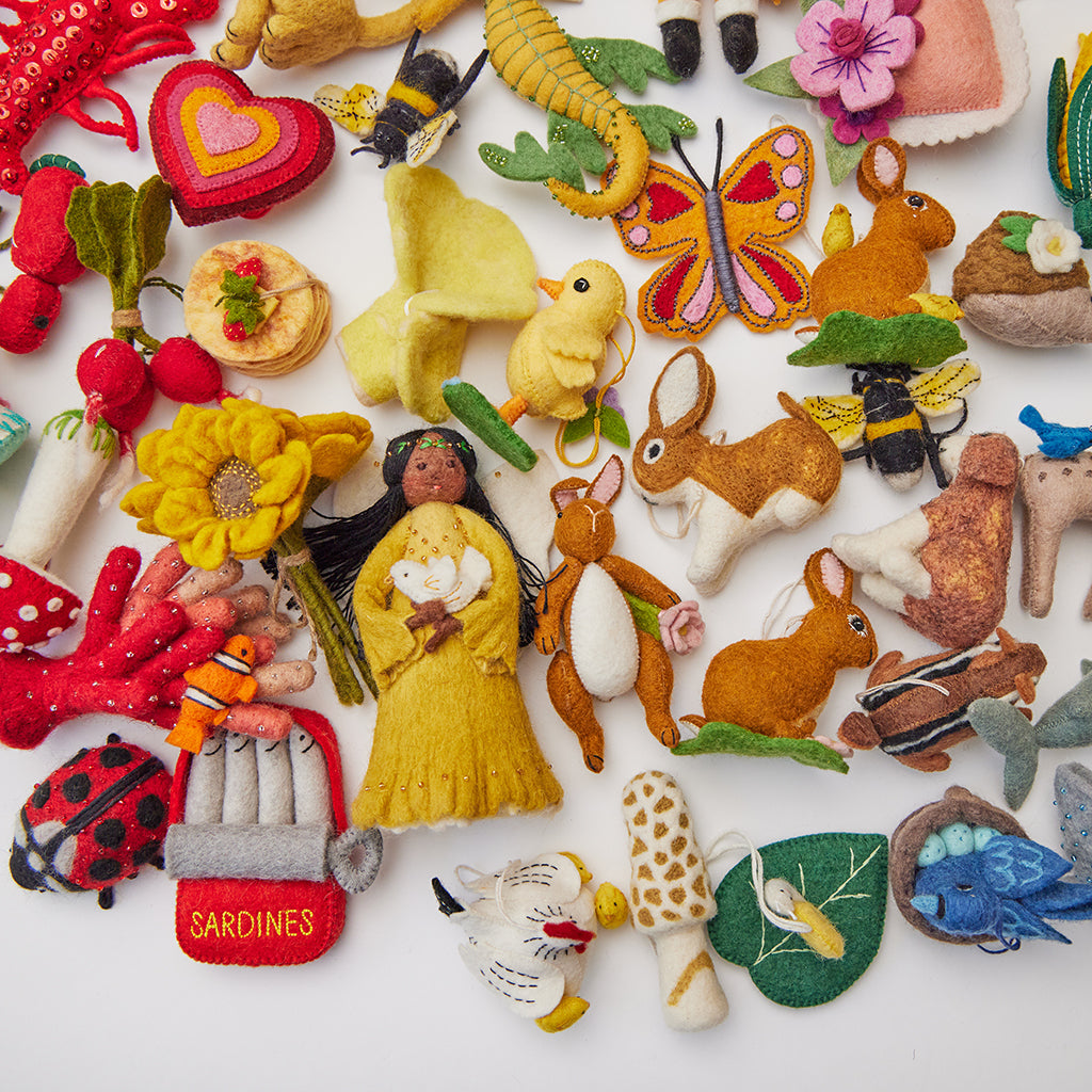 Delicate twin chanterelle mushrooms needle-felted in golden hues, showcasing handmade craftsmanship from Kyrgyzstan.
