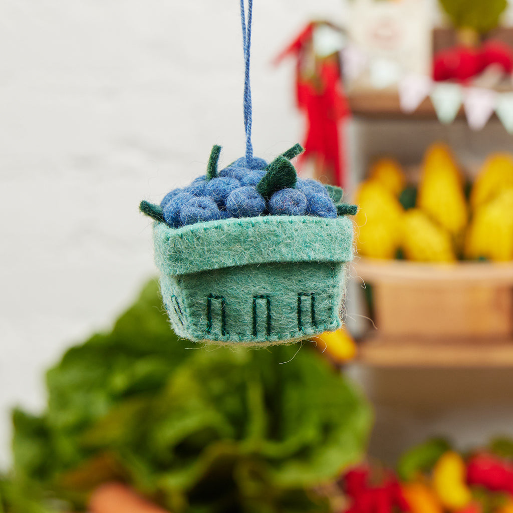 Felt blueberry pint ornament with hand-felted blue berries in a soft green wool basket. Handmade from natural wool felt using traditional needle-felting. Fair trade and ready to hang.