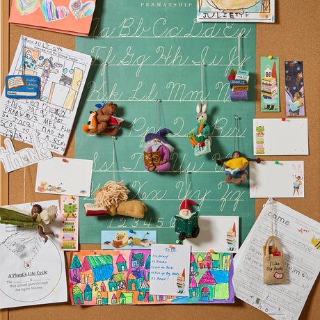 A whimsical reading-themed stationery set, including a notepad, bookmarks, and notecards. Each piece features charming illustrations of a lion reading, a gnome with a book, and a fairy immersed in a story, all drawn in warm, detailed artwork. Printed on natural white textured paper, this set is perfect for journaling, letter writing, or marking your place in a book. A delightful gift for readers, teachers, and those who appreciate a touch of literary magic. WIth Reading collection ornaments