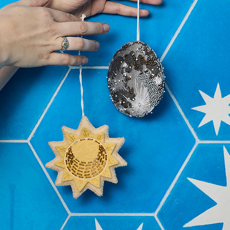 Felted wool sun charm ornament with sparkly gold details, perfect for nursery décor, holiday trees, or sacred spaces.