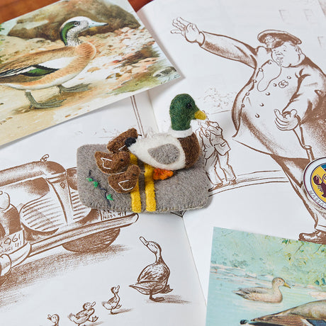 Mama duck with ducklings wool ornament capturing a classic storybook scene, made with detailed stitching.