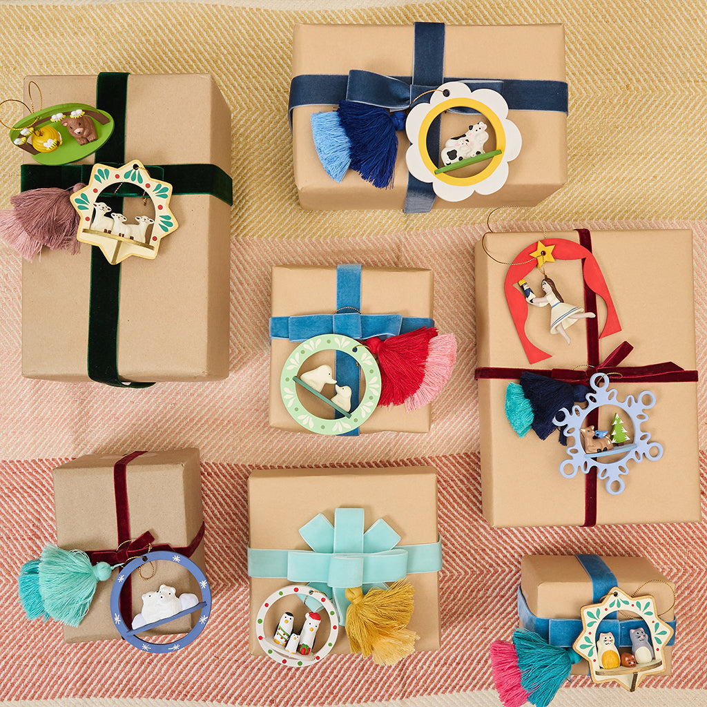 Handcrafted ornament made from wood and locally sourced clay with attached hanging string