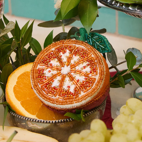Hand-beaded orange ornament with shimmering citrus details and linen backing, perfect for seasonal or kitchen décor.