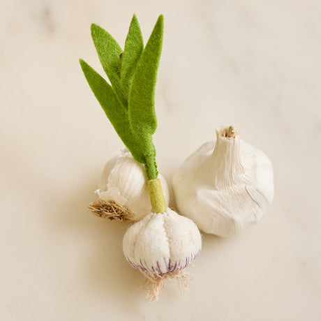 Hand-felted garlic plant ornament with wool bulb and curled scape – handmade wool holiday decor from the Gardening Collection.