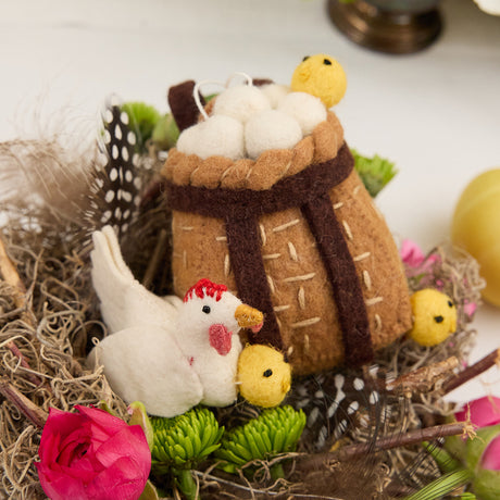 Whimsical felted hen ornament with backpack basket, celebrating springtime, motherhood, and farm life.