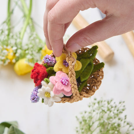 Colorful spring flower basket ornament made with raffia and felted merino wool