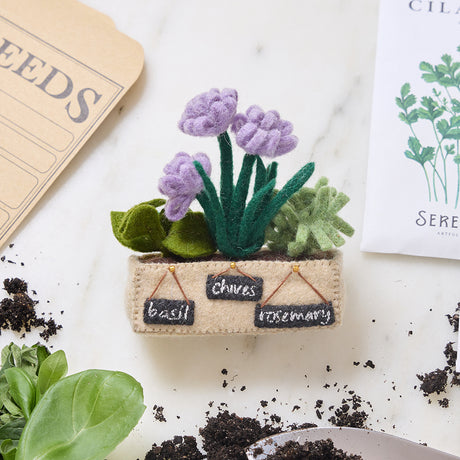 Handcrafted felt herb garden ornament with basil, chives, and rosemary in a cozy felt pot