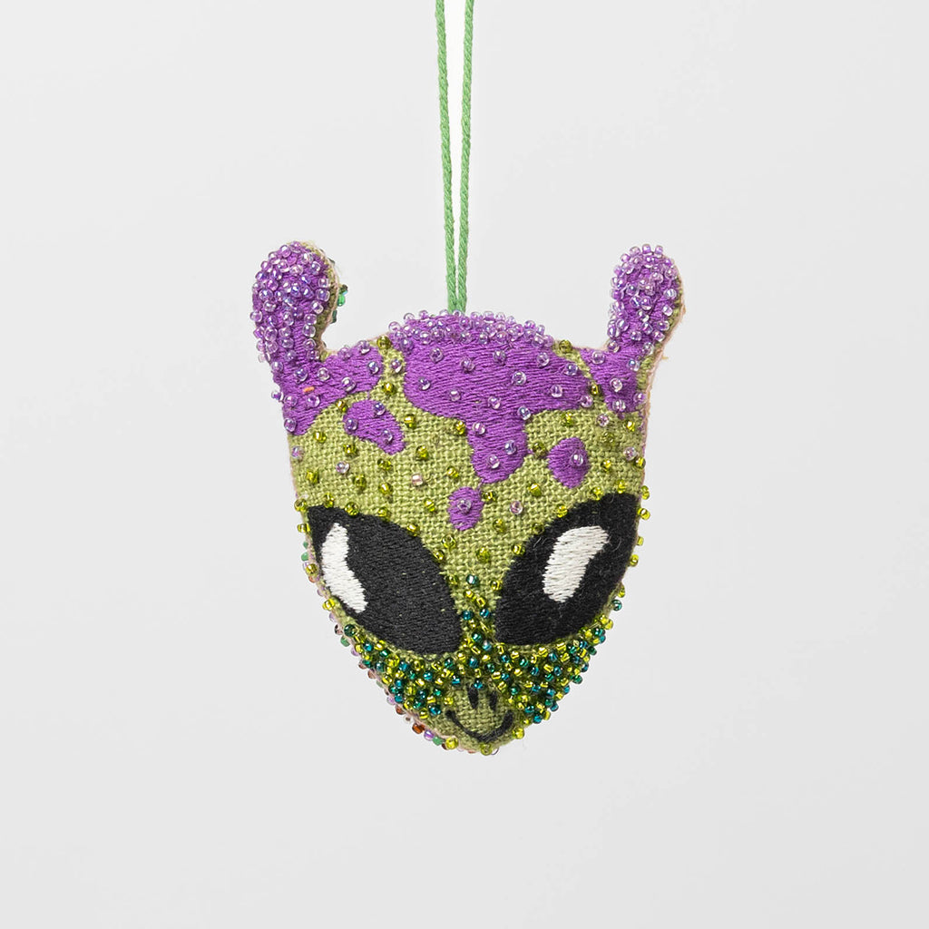 Linen-backed beaded alien ornament featuring cosmic embroidery, ideal gift for stargazers and science fiction fans.