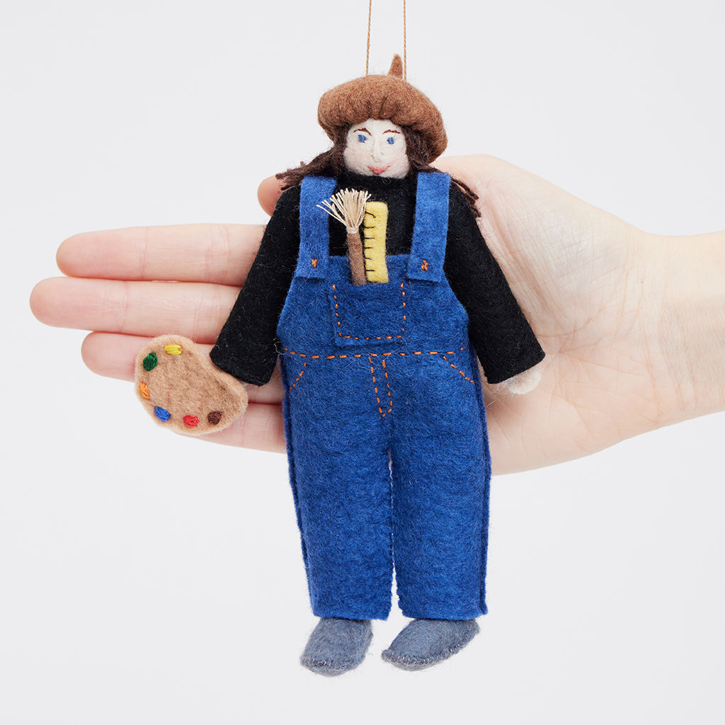 Artist-themed felt ornament featuring handmade wool figure with paintbrush and palette. Ethically crafted by women artisans in Kyrgyzstan. Ideal for creatives and holiday décor.