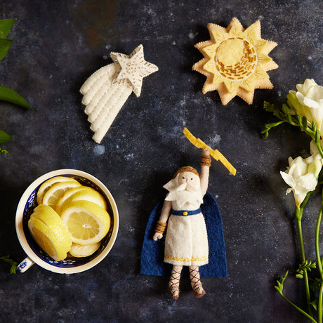 Artisan-made felt sun ornament featuring gold embroidery, symbolizing warmth, joy, and celestial wonder.