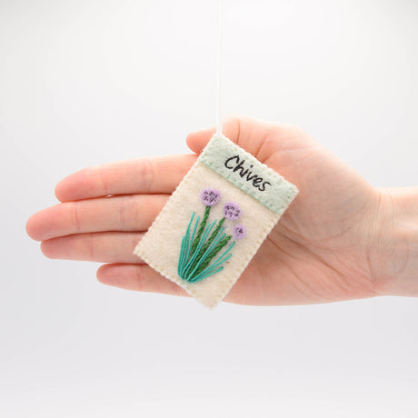 Handmade herb seed packet ornaments in felt—basil, chives, and rosemary with growing instructions