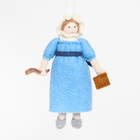 Handcrafted felt ornament of Jane Austen, featuring the beloved author standing with a feather quill in one hand and a felt copy of Pride and Prejudice in the other. She wears a period-style dress and bonnet, all made from natural merino-blend wool with fine stitched details. Includes a string for hanging and measures approximately 6 inches tall.
