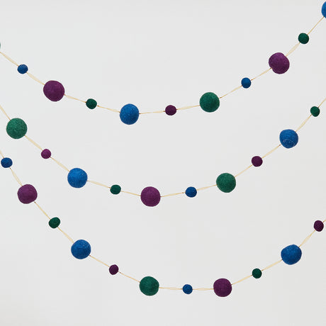 Handmade felt Jewel Tone Ball Garland from Craftspring, featuring deep jewel-tone felt balls strung on a gold ribbon—heirloom-quality holiday decor perfect for adding rich, festive color, ethically crafted by artisans using sustainable wool.