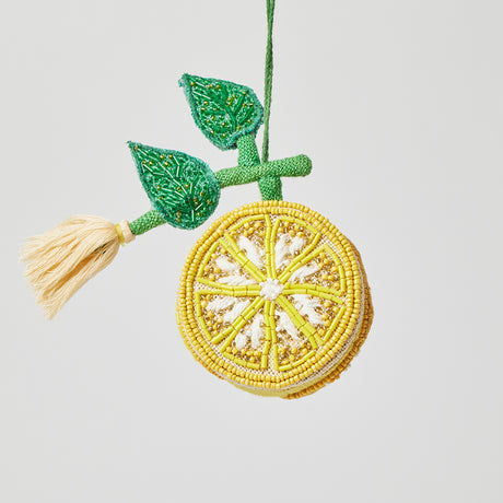 Handcrafted lemon ornament with beaded accents and tassel, ready to hang for seasonal or kitchen-themed decoration.