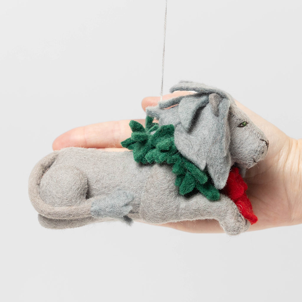 Handmade felt ornament of a regal lion statue adorned with a festive holiday wreath, inspired by the iconic lions outside the New York Public Library. Crafted from merino-blended wool, this ornament captures the spirit of NYC, literary tradition, and holiday cheer. A thoughtful gift for book lovers, librarians, and New York enthusiasts, perfect for trees, bookshelves, or desks. Ready to hang with a string attached.