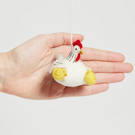 Fair trade wool ornament of a mother hen and her chicks, symbolizing springtime, family, and new beginnings.