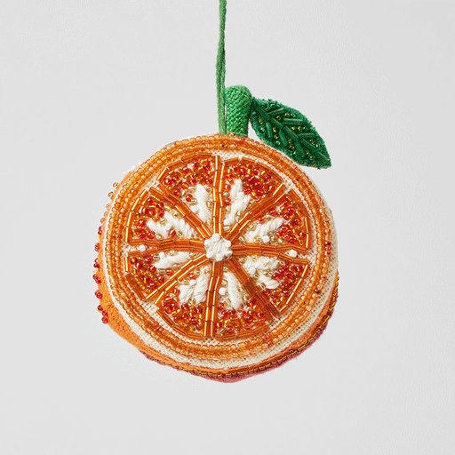 Bright orange beaded ornament with intricate beadwork and warm color tones, handcrafted from a cotton-linen blend.