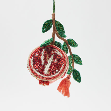 Symbolic pomegranate ornament with red and green beaded accents, handmade for meaningful gifting and seasonal displays.