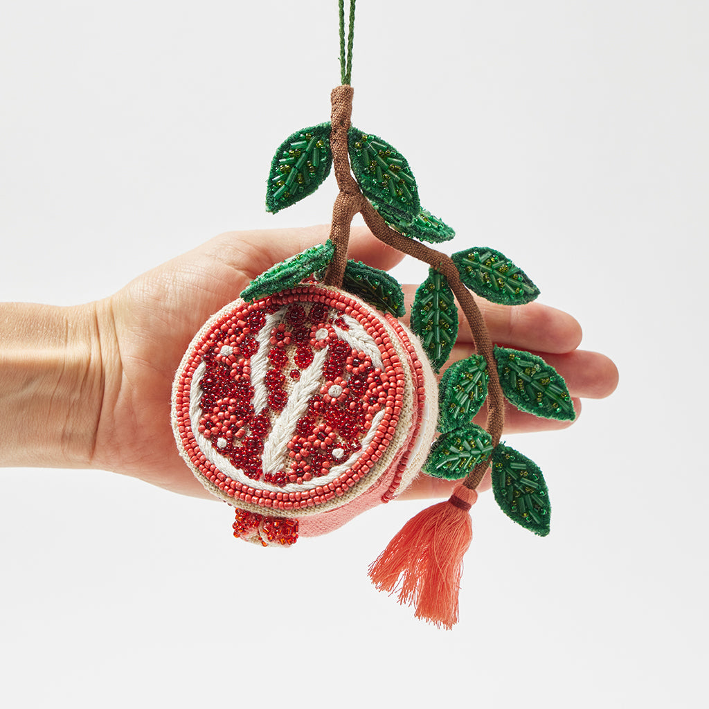 Intricately beaded pomegranate ornament symbolizing fertility and abundance, fair trade and ready to hang.