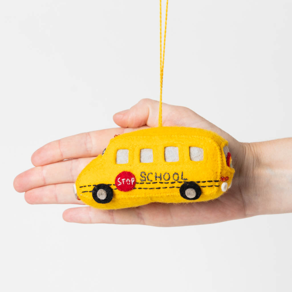 Felt yellow school bus ornament with red lights, handmade and fair trade.