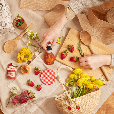 Lightweight raffia basket for kids with hand-stitched fruit, perfect for gathering or gifting.