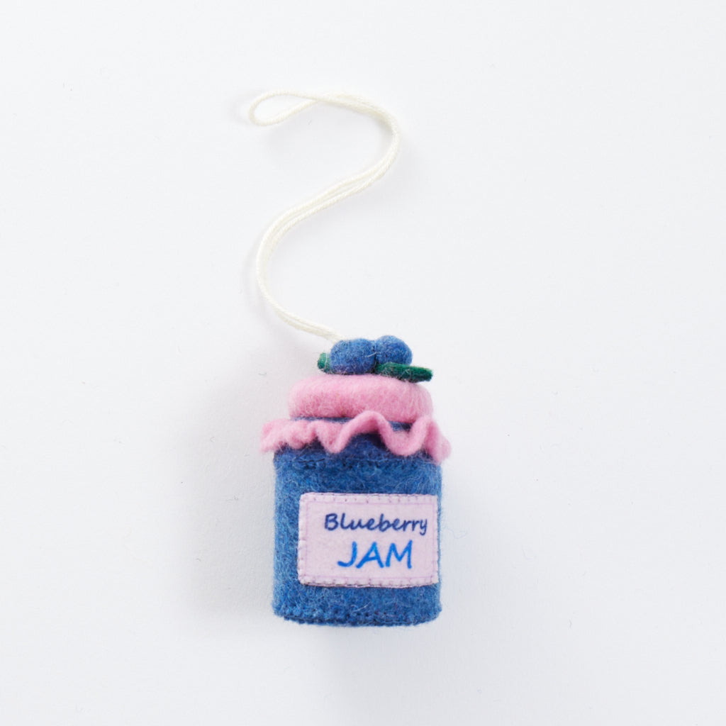 Hand-felted blueberry jam jar ornament with a gingham-style lid and a bunch of plump felt blueberries on top. Made from merino-blend wool, this 3-inch tall ornament is a charming, summer-inspired gift for bakers and brunch lovers. Perfect for cottagecore décor, holiday trees, or breakfast-themed bundles.