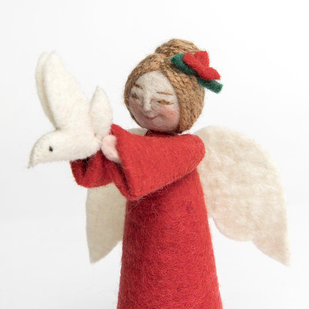 A Craftspring handmade felt angel ornament with her brown hair in a bun with a red flower wearing red robes and holding up a small white dove