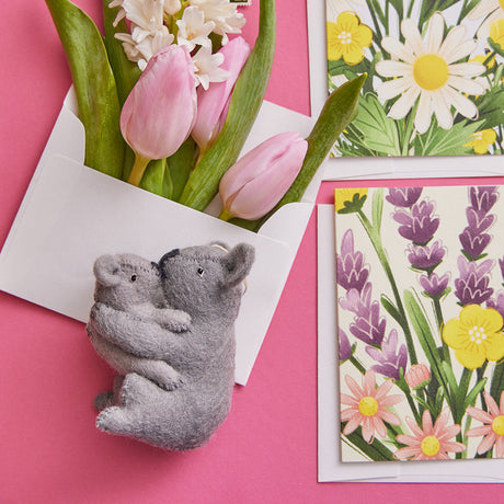 Handmade felt Christmas ornament from Craftspring’s Family Collection, featuring a mama and baby koala, paired with floral greeting cards—heirloom-quality holiday decor, ethically crafted by women artisans in Kyrgyzstan using sustainable wool.