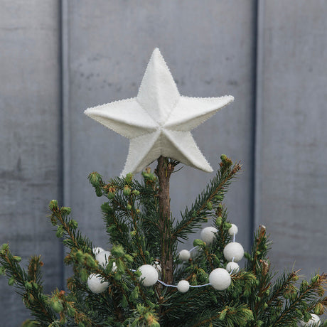 Handmade Star Tree Topper, Part of Craftspring's Collection of Christmas Garlands & Tree Toppers —ethically handmade by artisans using sustainable wool, displayed with evergreens and snow for a festive holiday scene.
