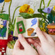 Handmade felt gardening book ornament with embroidered seed planting and watering illustrations