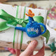 Whimsical watering can ornament with butterfly, crafted from natural felt for garden-inspired decor
