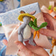 Felt bunny carrying spring veggies – handcrafted wool ornament for Easter baskets, gardeners, or woodland animal lovers.