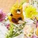 Hand-felted beehive ornament with tiny wool bees and stitched sunflower detail