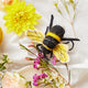 Handcrafted felt bee ornament made from merino-blend wool, supporting pollinator education
