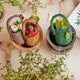 Wool felt strawberry ornament with red berries and caterpillar in handmade felt basket.