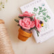 Handcrafted felt Garden Rose Pot ornament with blush-colored roses, a woolen pot, and embroidered buzzing bees—bringing springtime charm to indoor displays