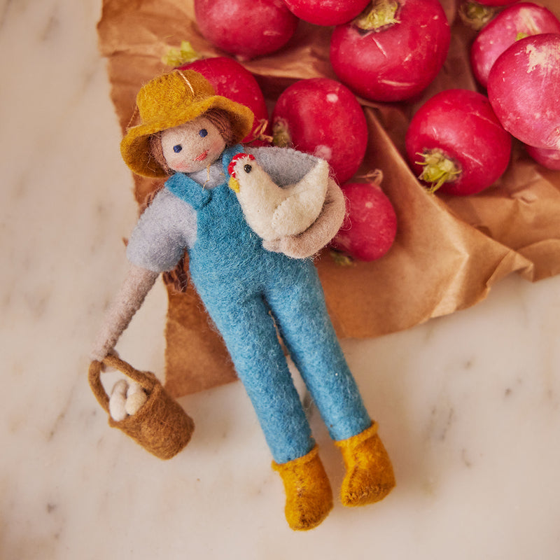 Hand-felted female farmer ornament with chicken and basket of felt eggs – handmade wool decoration from the Gardening Collection.