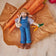 Hand-felted farmer ornament holding white bunny and felt carrots – wool spring decor from the Gardening Collection.