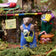 Wool felt woodchuck ornament holding gardening accessories, beautifully stitched with beaded accents—ideal for garden lovers and nature-inspired decorating

