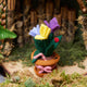 Eco-friendly felt ornament with purple crocus flowers in a wool pot, adorned with a garden scene of embroidered bugs and a delicate bow—perfect for Easter or spring displays