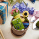 Charming wool sunflower in tiny felted pot – artisan-crafted ornament with beaded sparkle and floral charm.