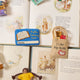 Handmade felt ornament shaped like a tote bag filled with miniature felt books and library card ready to check them all out. Crafted from soft merino-blended wool, this quirky ornament is a playful nod to literary humor. Perfect for bookworms, teachers, librarians, and pun enthusiasts, it adds a clever touch to holiday trees, bookshelves, or classrooms. Ready to hang with a string attached.