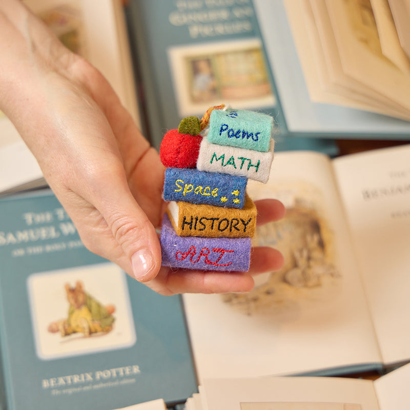 Handmade felt ornament of a colorful stack of books from the Reading Collection – a cozy tribute to readers, teachers, and bookworms who find magic in the margins.