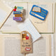 Bestselling ornaments from our reading collection; Handmade felt ornament of a colorful stack of books, library card and book tote – a cozy tribute to readers, teachers, and bookworms who find magic in the margins