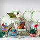 Handmade felt ornament of a fairy with delicate wings and a leafy green tunic, reading an oversized open book embroidered with whimsical details. Featured with  other adorable readers and a stack of books. Perfect for fairy collectors, book lovers, and dreamers, it brings a magical, literary touch to bookshelves, holiday trees, or cozy reading spaces. Ready to hang with a string attached.