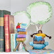 Handmade felt ornament of a young girl sitting cross-legged, absorbed in a book. Crafted from natural merino-blended wool, her focused gaze and relaxed posture capture the magic of reading. With braided brown hair and a warm-toned complexion, this ornament adds a cozy, literary touch to reading nooks, desks, or shelves. A perfect gift for bookworms, young readers, or anyone who treasures the quiet joy of a good story. Ready to hang with a string attached.